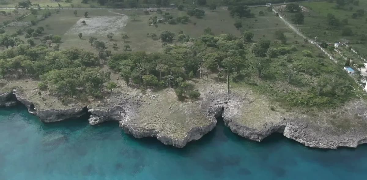 Rocky cliff coast with clear shallows